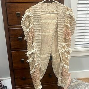 Sweater. Open in the back.